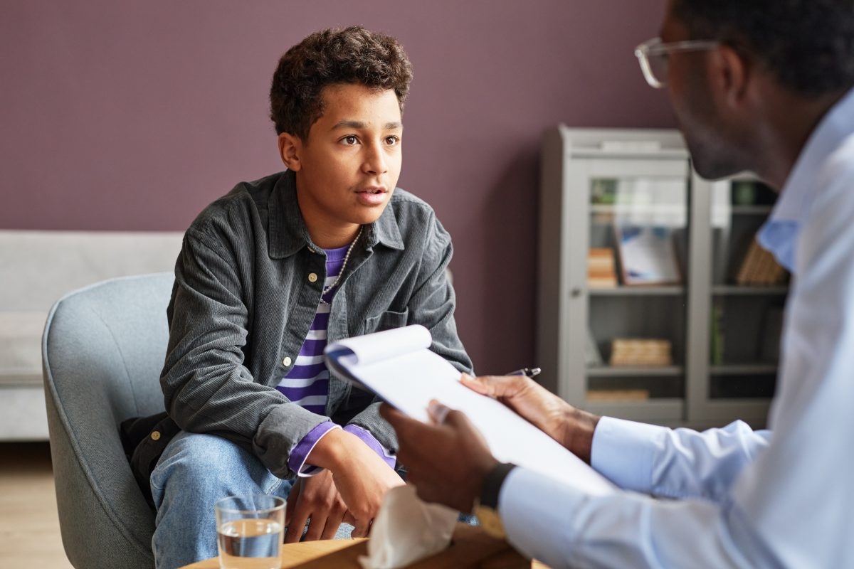 A young person talking with a clinician